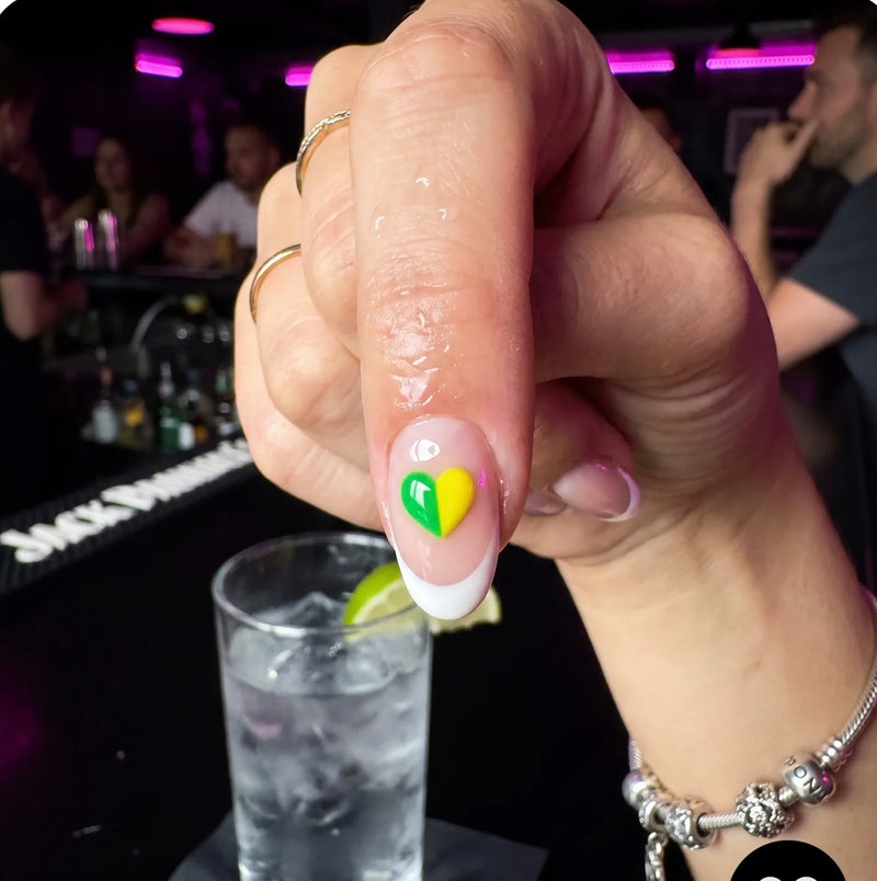 Close-up of a heart-shaped drink test sticker in a bar